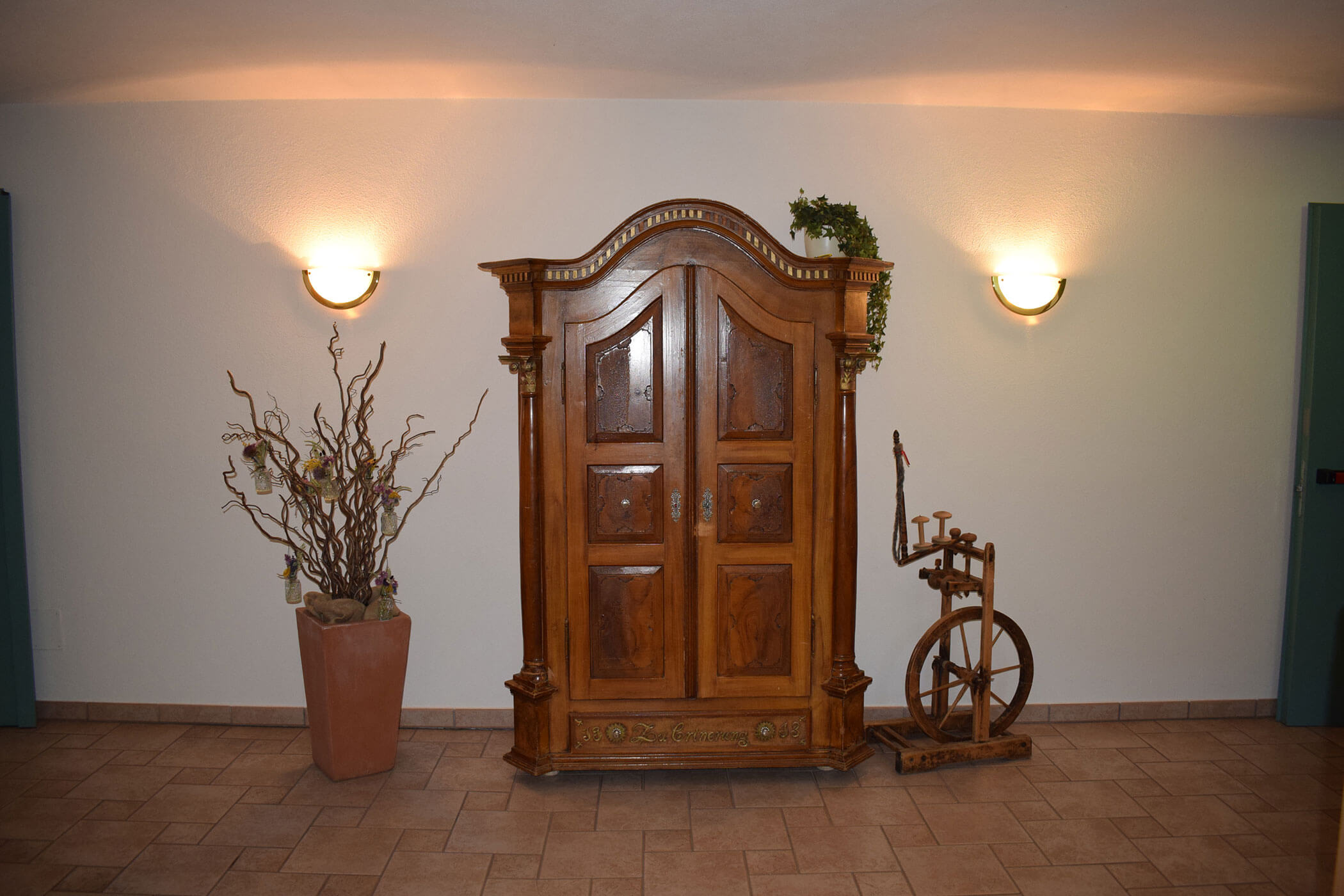 In una stanza c'è un armadio di legno accanto a un arcolaio.